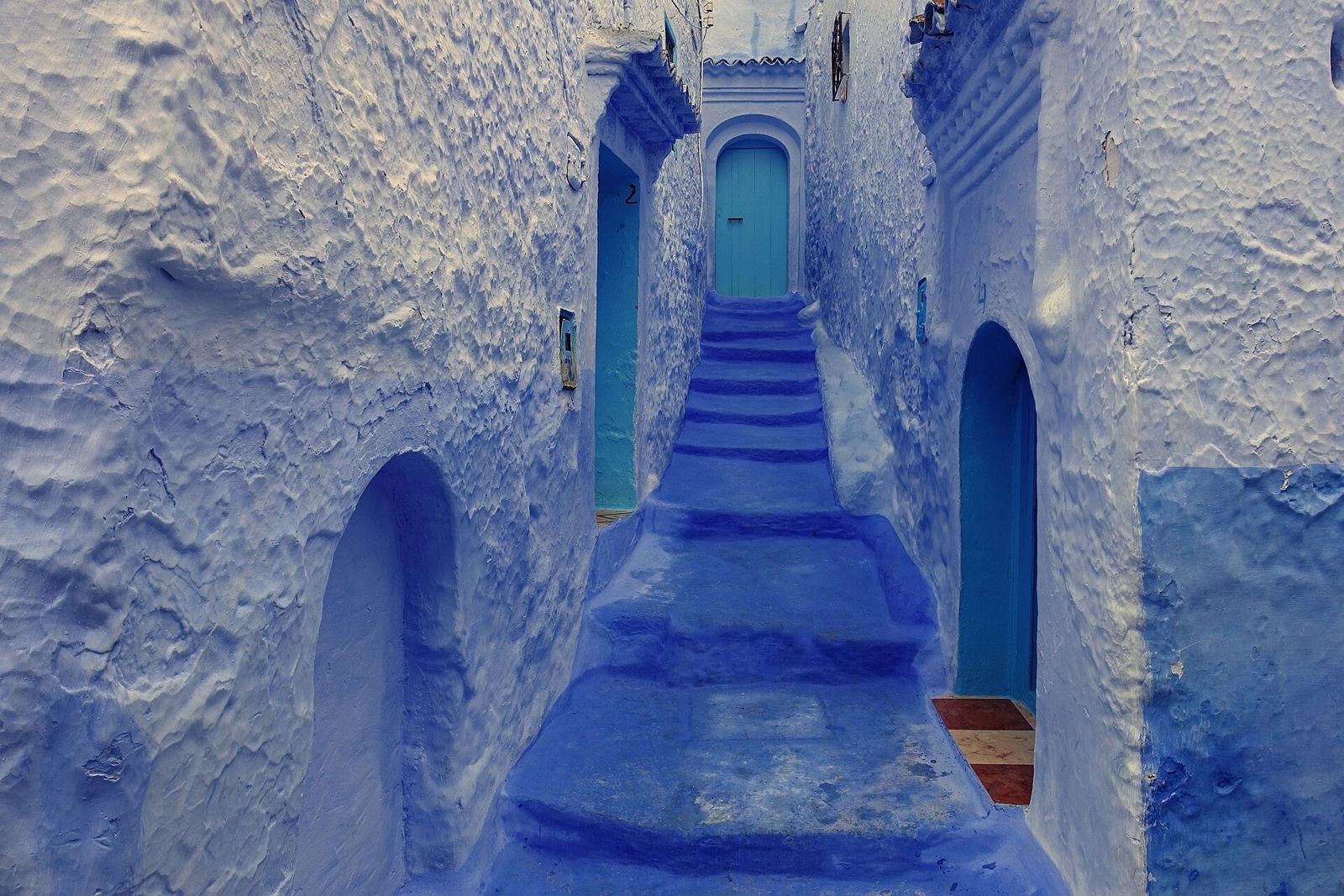 Blue-washed stairway and doorways in the old medina of Chefchaouen, Morocco